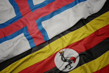 waving colorful flag of uganda and national flag of faroe islands.
