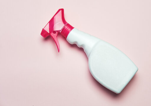 High angle of plastic spray bottle placed on pink background in studio