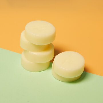 Natural round shaped soap arranged on two colored background in studio