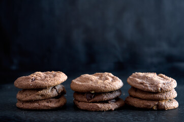 Stacks of Delicious Homemade Chocolate Cookies on Dark Background