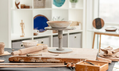 Potter's wheel and pottery tools at workshop