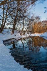 The colors of a winter evening reflected on the water