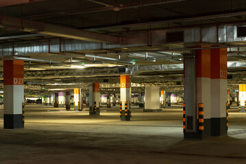 Empty underground parking lot. Marked parking in the basement of the shopping center