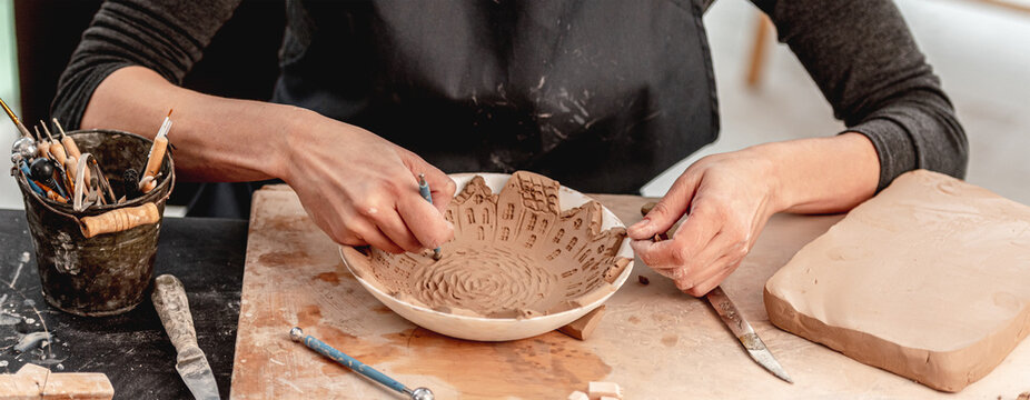 Woman Using Pottery Tools For Making Patterns