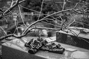 Crucifix with roses on a grave