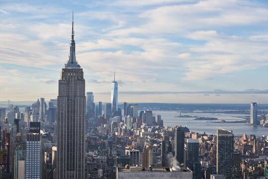 Magnificent view of Manhattan with tall glass skyscrapers on background of blue cloudy sky in New York