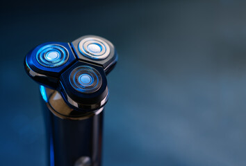 Men's electric razor , blue neon background, copy space