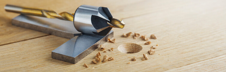 Countersink drill bit with steel triangle ruler make sink in hole for screw in wooden oak plank