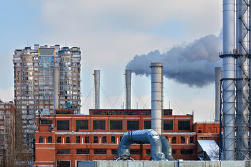 Clouds of smoke rise into the sky from the heat station of the city district, worsening the...