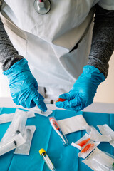 Detail of a nurse's hands preparing a covid vaccine