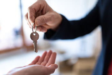 State agent giving keys to a new lady's house