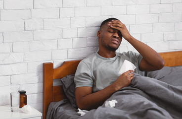 Sick African American Guy Having Fever And Headache At Home