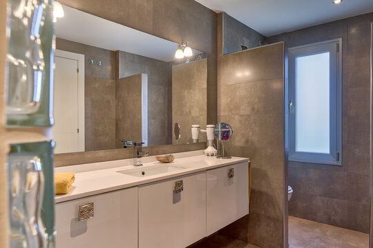 Modern interior of bathroom with sink in white and beige colors in apartment