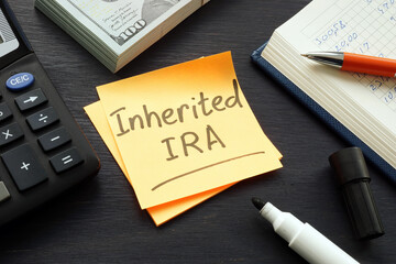 Inherited IRA memo on the color paper and calculator. - obrazy, fototapety, plakaty