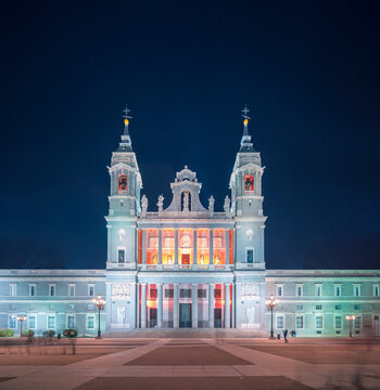 Scenic view of Almudena Cathedral with illuminated windows on background of dark night sky in Madrid
