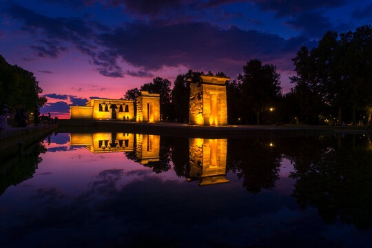 Amazing view of Temple of Debod located near pond in Madrid at sundown