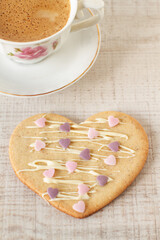Fototapeta na wymiar Homemade decorated heart shaped cookies for breakfast on a table