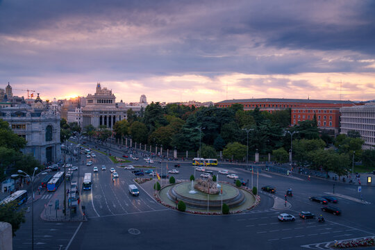 Wonderful scenery of Plaza de Cibeles with traffic under sunset sky in Madrid