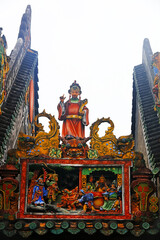 Fototapeta na wymiar Beautiful colored sculptures on the roof, in an ancient ancestral hall, Guangzhou City, Guangdong Province, China