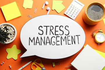 Flat lay composition of speech bubble lightbox with phrase Stress Management on orange background
