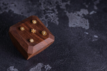 Beautiful piercing jewelry on wooden display. Macro shot. Selective focus.