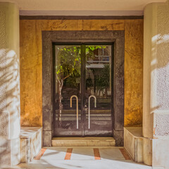 residential apartment building main entrance metal and glass door, Athens, Greece.