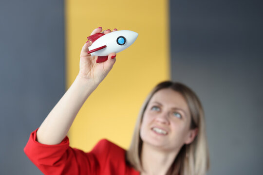 Business Woman Holding Toy Rocket In Hands In Office