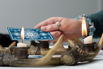 Fortune teller is reading the future with a tarot cards close up concept.