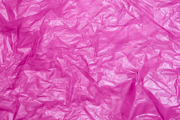 Fototapeta premium Crumpled red lilac plastic bag abstract texture background surface