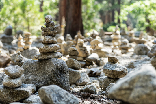 Stones stacked on rock in woods on sunny day in Yosemite National Park