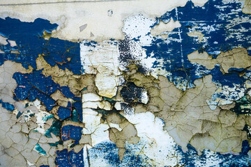 Texture of old concrete wall with many peeled paint layers