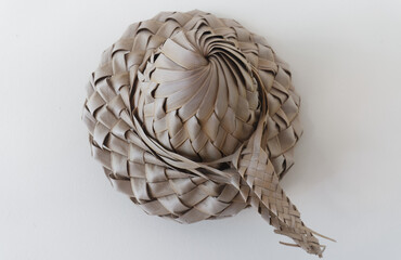 Bakoua hat on the white background. It is a typical Caribbean Straw Hat, made from the leaf of the tree.