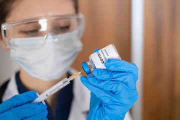 Doctor, nurse, scientist hand in blue gloves holding flu, measles, coronavirus, covid-19 vaccine disease preparing for child, baby, adult, man and woman vaccination shot, medicine and drug concept.