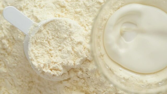 Milk is poured into a glass over vegan cookie