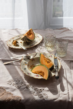 From above of slices of sweet melon served in plate on table in countryside on sunny day