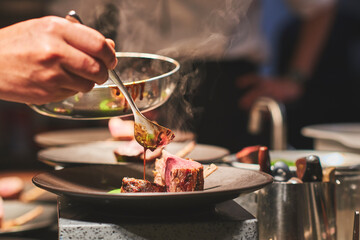 Chefs preparing beautiful dishes in French restaurant's kitchen