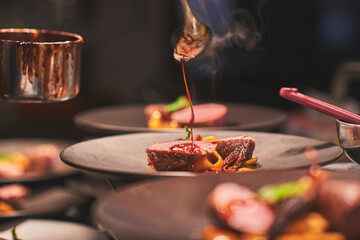 Chefs preparing beautiful dishes in French restaurant's kitchen