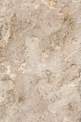 Empty, rough, uneven texture of a brown concrete wall close up with copy space