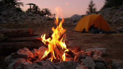 Bonfire burning in tourist camp in mountains.