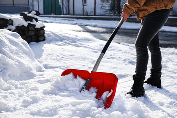 Person shoveling snow outdoors on winter day, closeup © New Africa