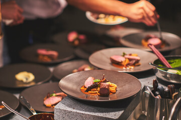 Chefs preparing beautiful dishes in French restaurant's kitchen
