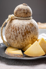 Italian semi hard matured caciocavallo cheese, handmade and aged in natural underground caves in...