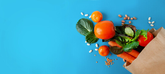 paper bag of vegetables and fruits, or healthy food delivery background. Healthy vegetarian food, copy space. Food supermarket and pure vegan food concept.