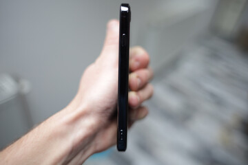 Closeup shot of a person holding a slim smartphone