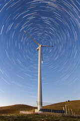 Windmill plant with the night sky as background