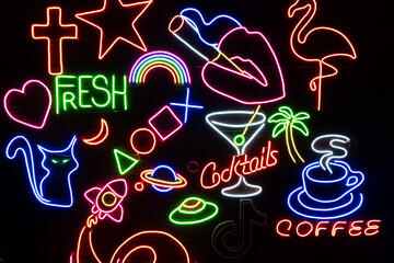 Neon assorted shapes on a black wall. Glowing multi-colored neon.