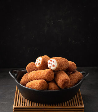 Croquettes served in a bowl on dark background