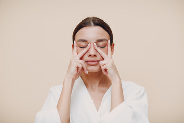 Young woman doing face building facial gymnastics self massage and rejuvenating exercises