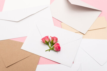 top view of tea roses on envelopes and letters