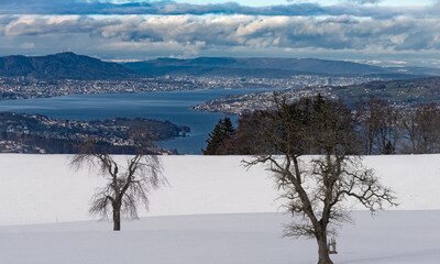 Distant view of the lake and city of Zurich on a winter day from the heights of the Etzel Kulm in canton Schwyz, Switzerland